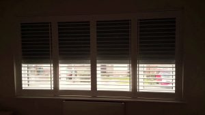window shutters to block out sun with a blackout blind