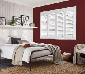 shutters behind a bed