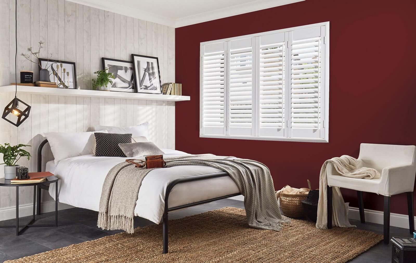 shutters behind a bed