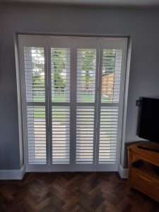 Window shutters on french doors in the closed position